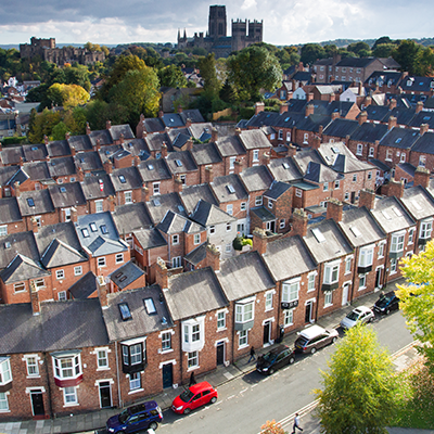 Aerial view of densely packed terraced housing with no off-street parking, highlighting the challenges of EV charging for residents with on-street parking.